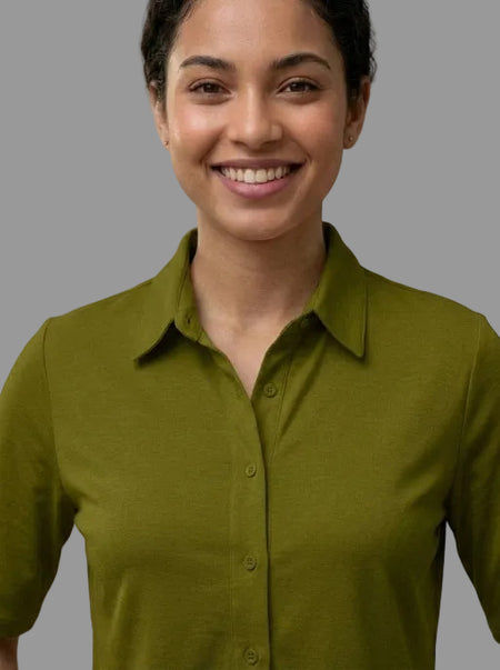 Woman wearing a green shirt against a neutral background